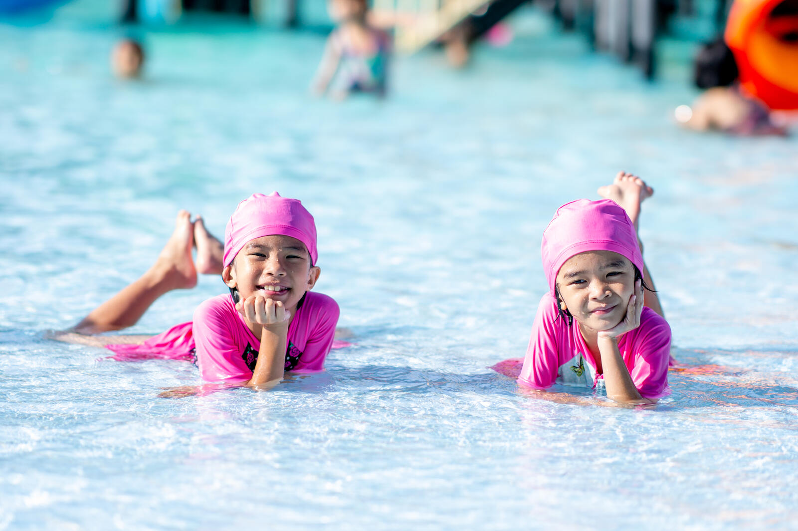 Twins enjoying a safe shallow-water pool. 