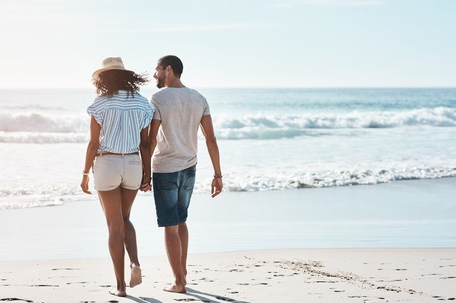 A couple enjoying a romantic walk on Hua Hin Beach